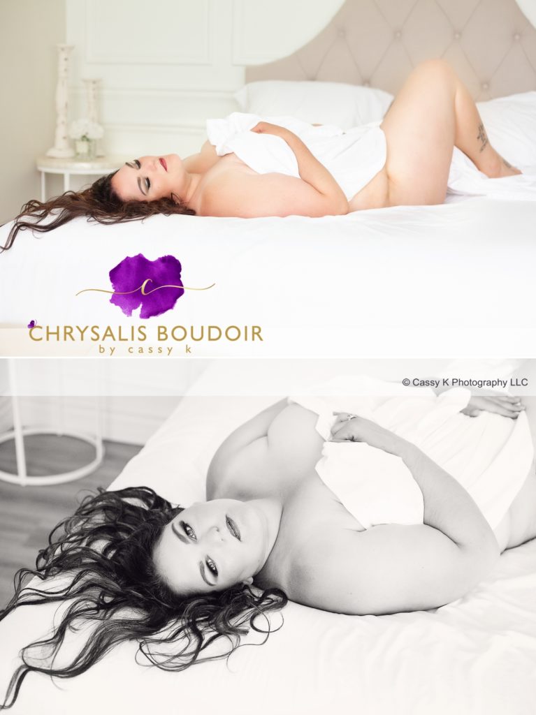 Curly brunette is a Beauty Beyond Size laying on bed with a white sheet only for Boudoir Photoshoot