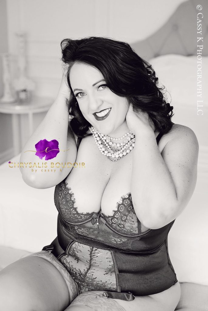 Brunette hair and blue eyed woman smiling feeling like princess for a day with Boudoir Photoshoot