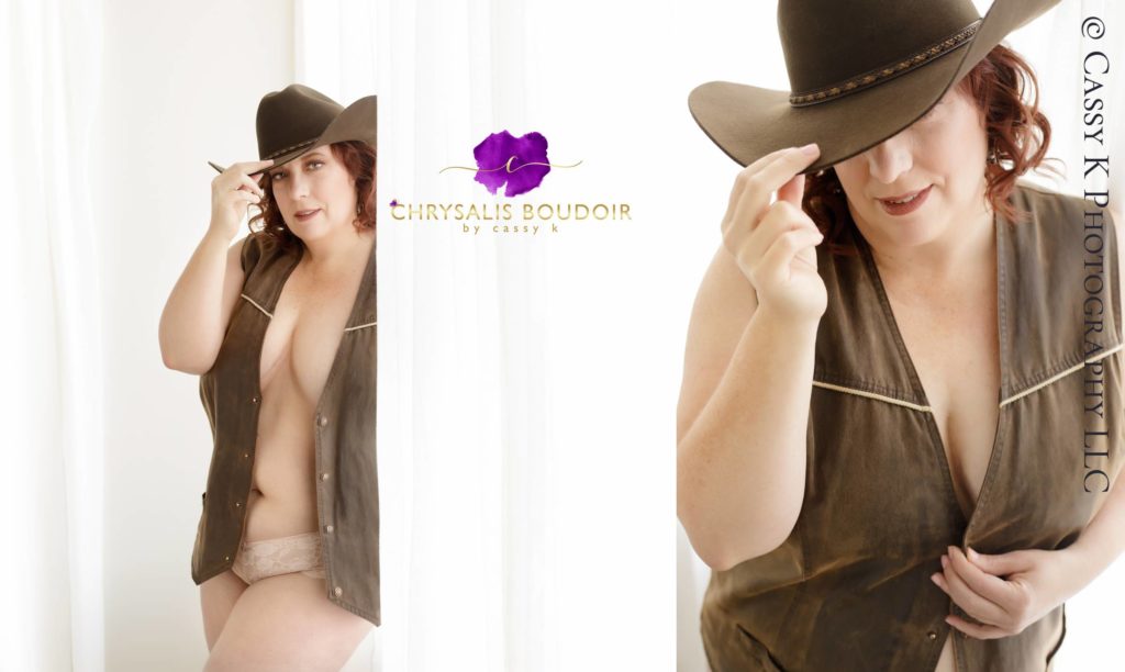Red haired and blue eyed woman wearing cowboy hat claims she's not photogenic at Boudoir Photoshoot