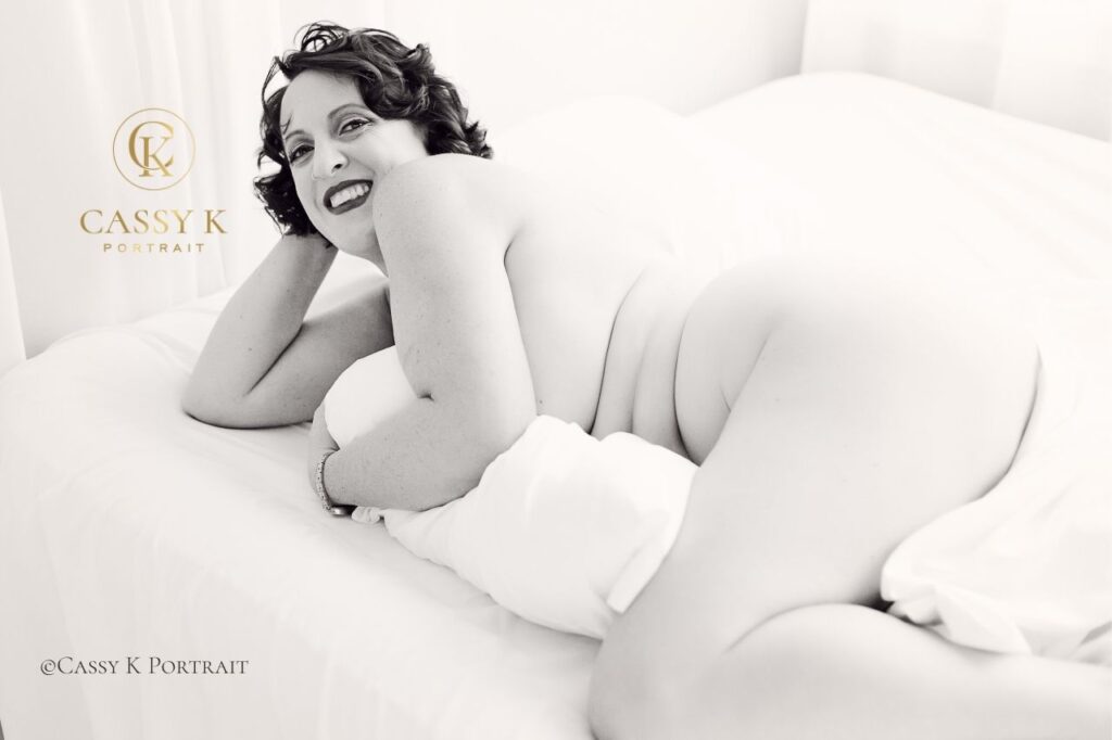 Brunette Blue eyed woman smiles confidently body confidence boudoir photography