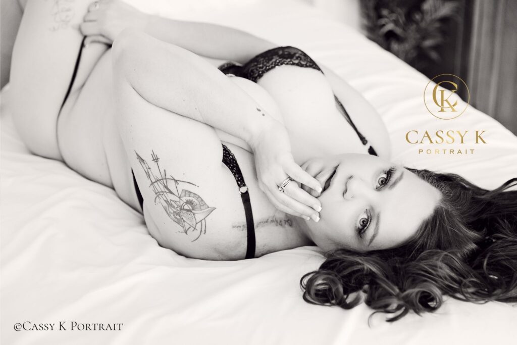 Burgundy Blond hair and blue eyed woman exploring empowering boudoir journey with black & white photography