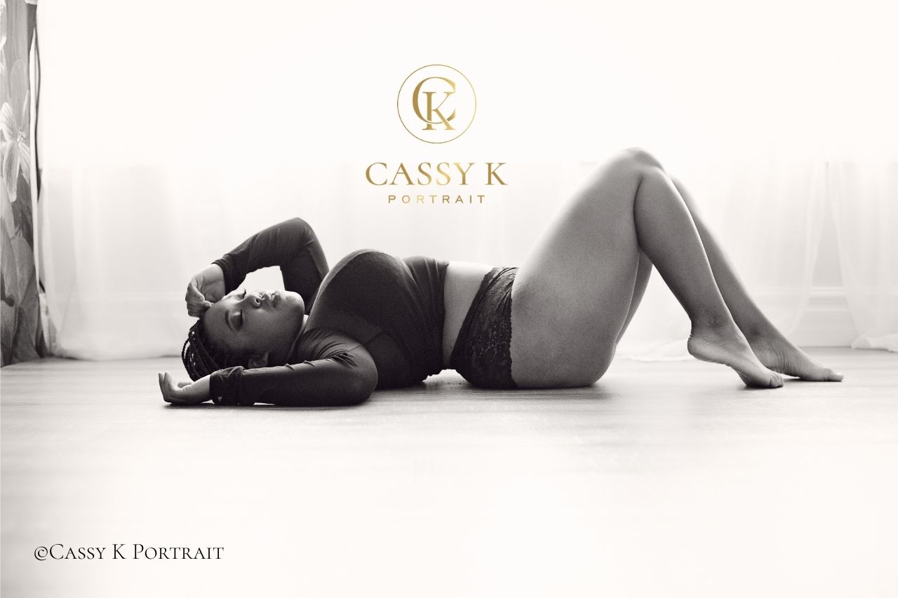 Black woman faces boudoir shoot fears laying on wood floor