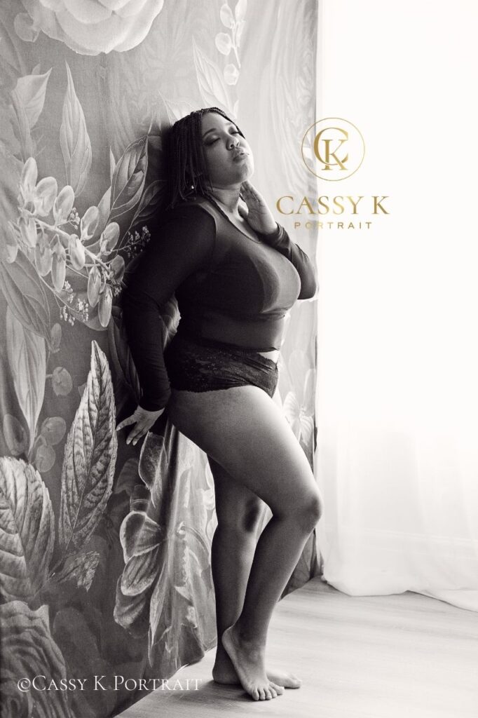 Black woman faces boudoir shoot fears standing in sheer black top and panties