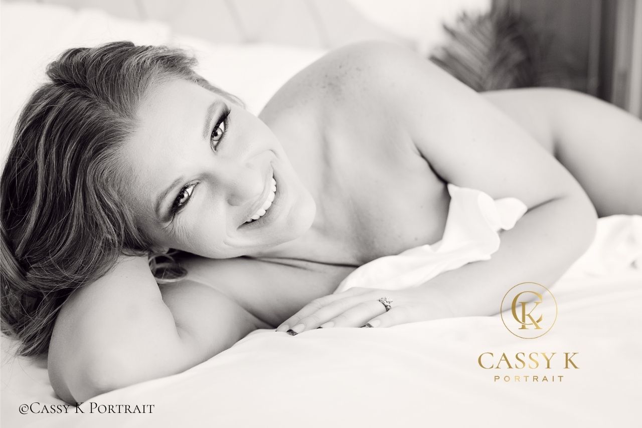 Blond hair and blue eyed woman with white sheet for boudoir shoot after 40