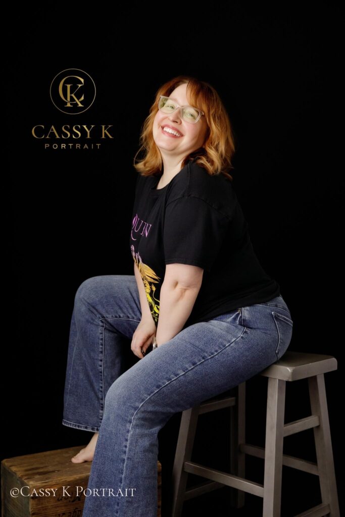 Laughing Blond hair and blue green eyed woman learns to love body image after 40 for headshot photo shoot