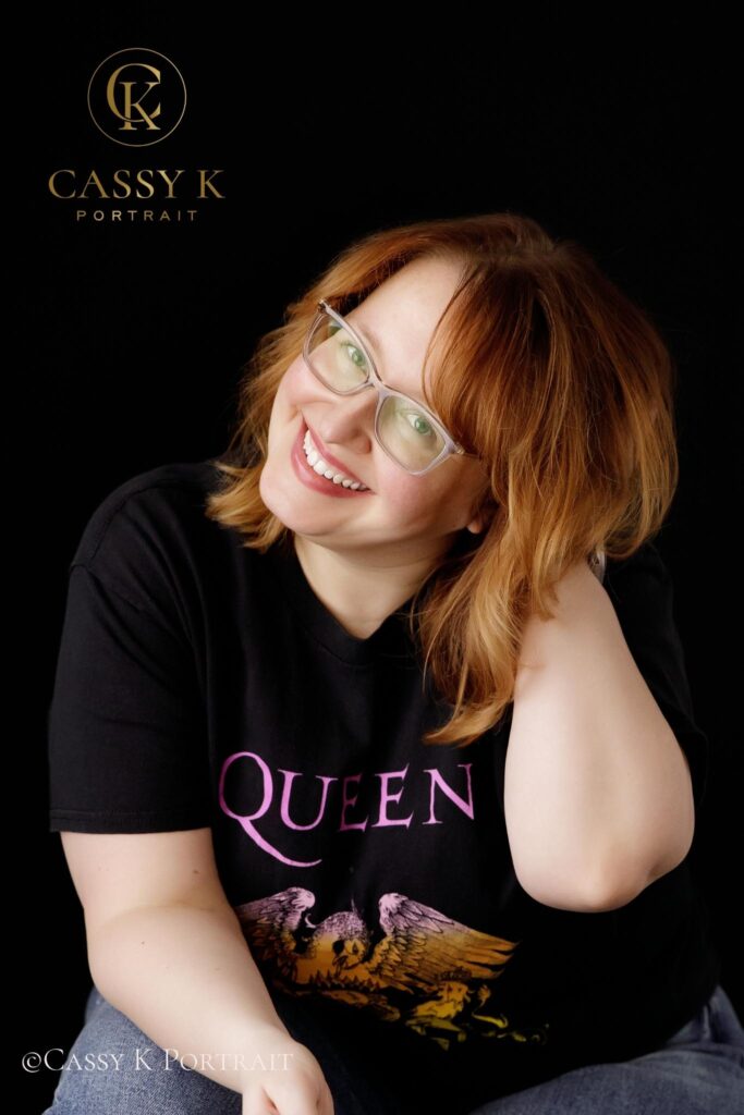 Happy Playful Blond hair and blue green eyed woman learns to love body image after 40 for headshot photo shoot