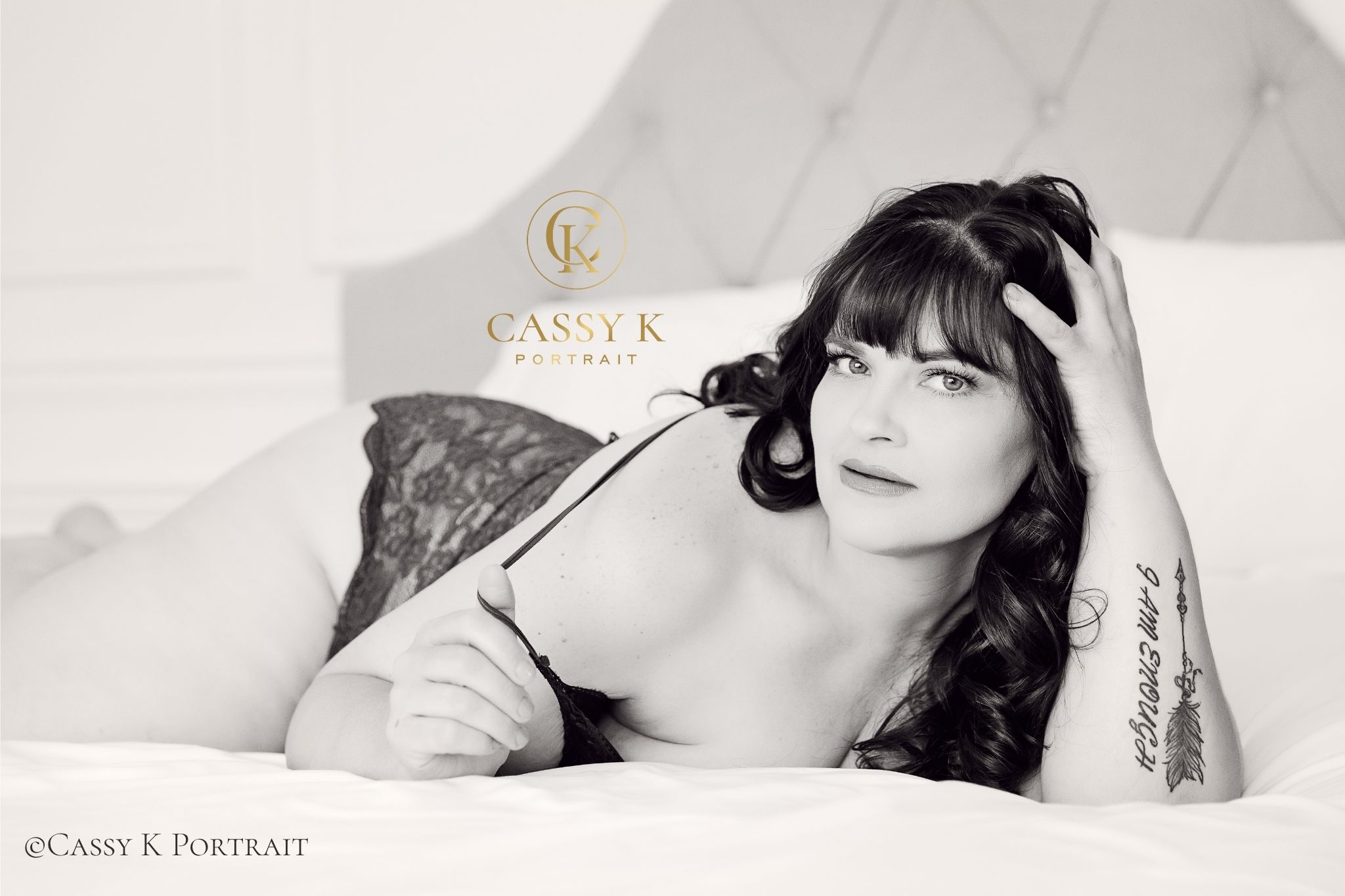 Brunette hair and green eyed woman investing in self love during black and white Boudoir Photoshoot
