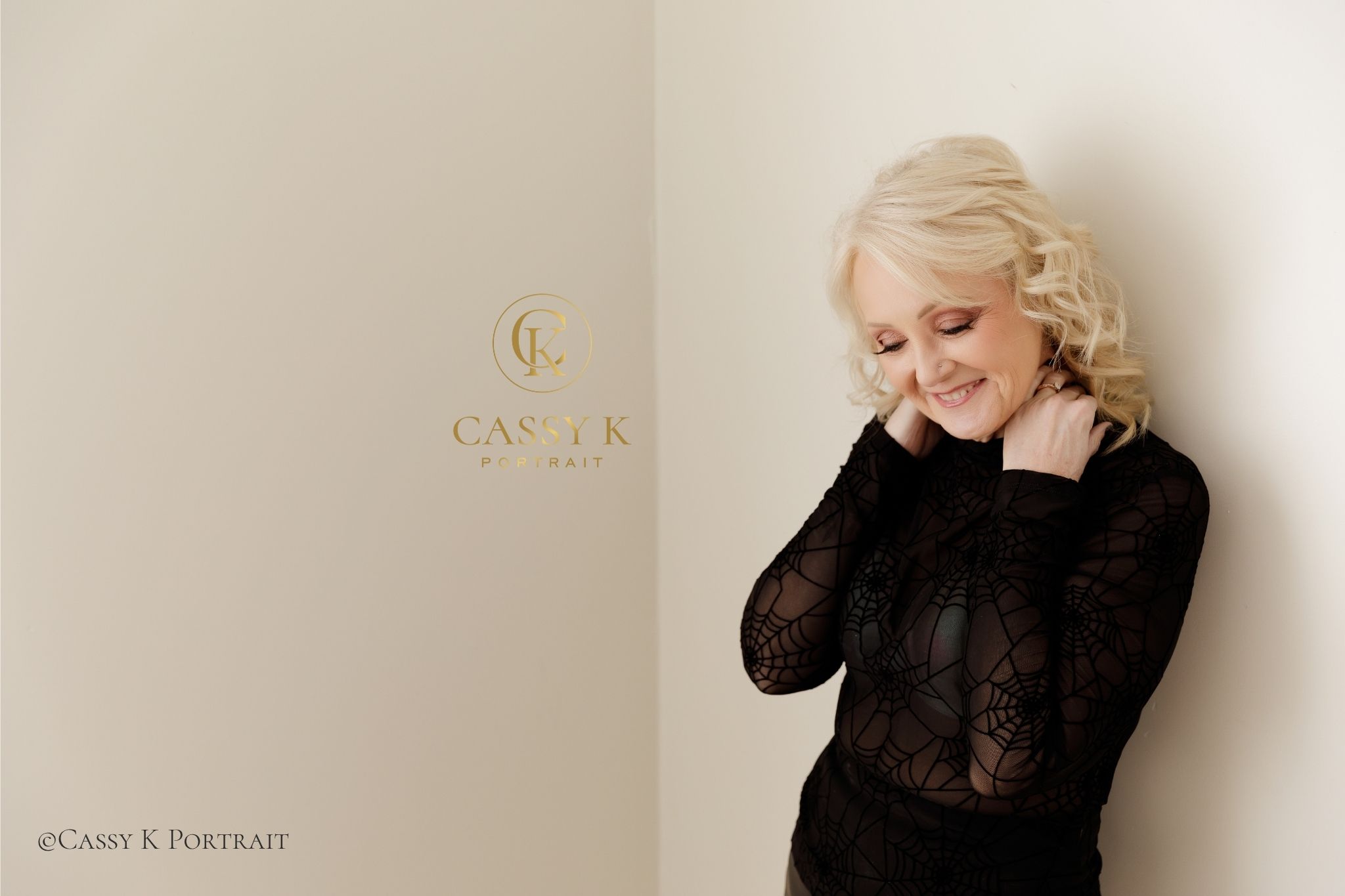 Blonde haired blue eyed woman smiling wearing black top experienced confidence beyond expectations at Boudoir Photoshoot